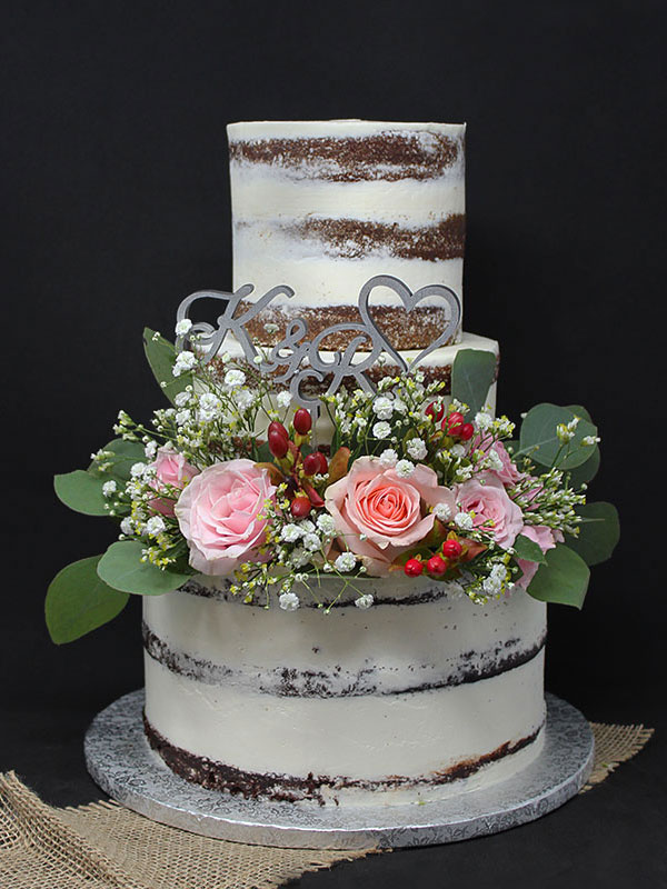 3 section semi-naked wedding cake with flowers